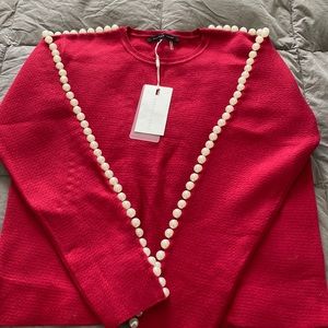 Adorable red sweater with Pearl detail ideal for the holidays